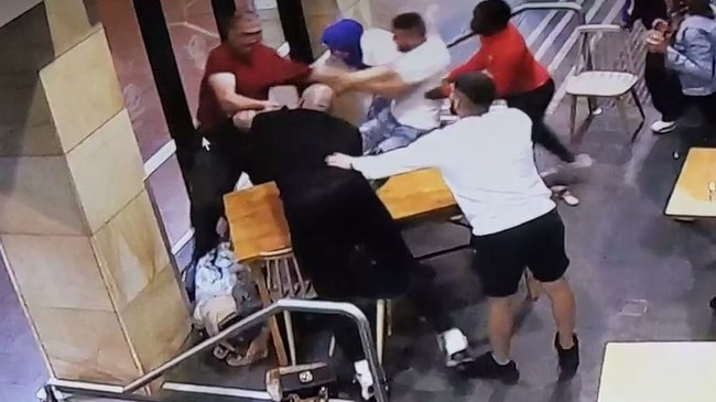 CCTV shows bystanders trying to stop Lozina assaulting Mrs Elasmar at the Bay Vista cafe.