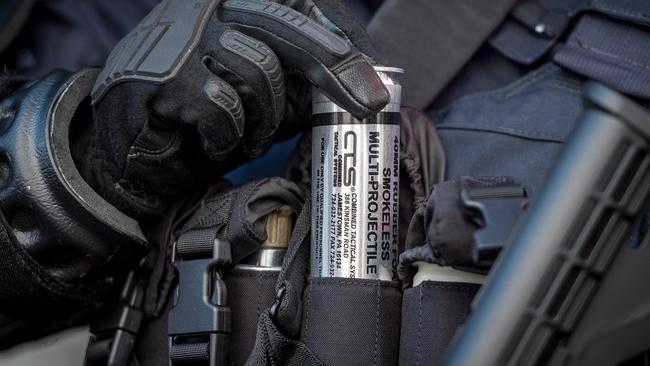 A Public Order Response officer displays a Multi Baton Round. Picture: Jake Nowakowski