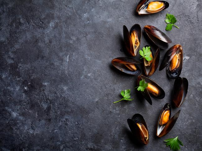 Mussels on stone table. Top view with copy space