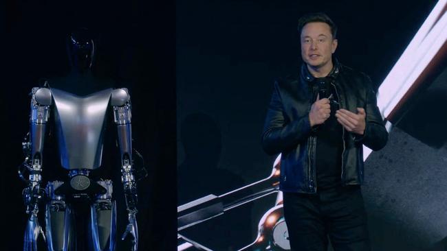 Elon Musk standing on stage next to Optimus the humanoid robot. Picture: Supplied