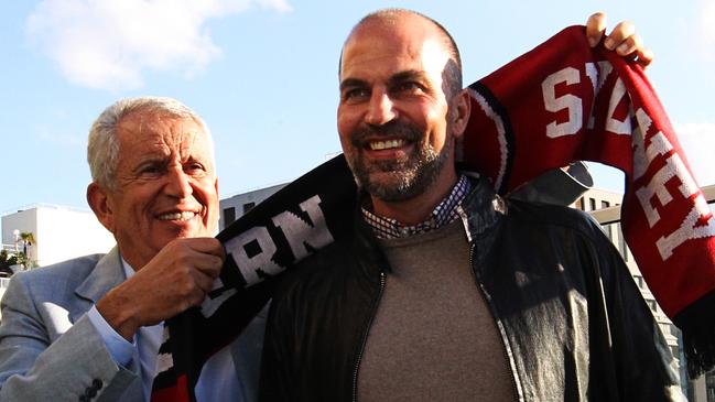 Western Sydney Wanderers Club Chairman Paul Lederer (left) places a scarf around Markus Babbel