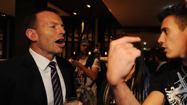 Tony Abbott enjoys a beer as he chats with a Penrith Panthers supporter. Picture: AAP