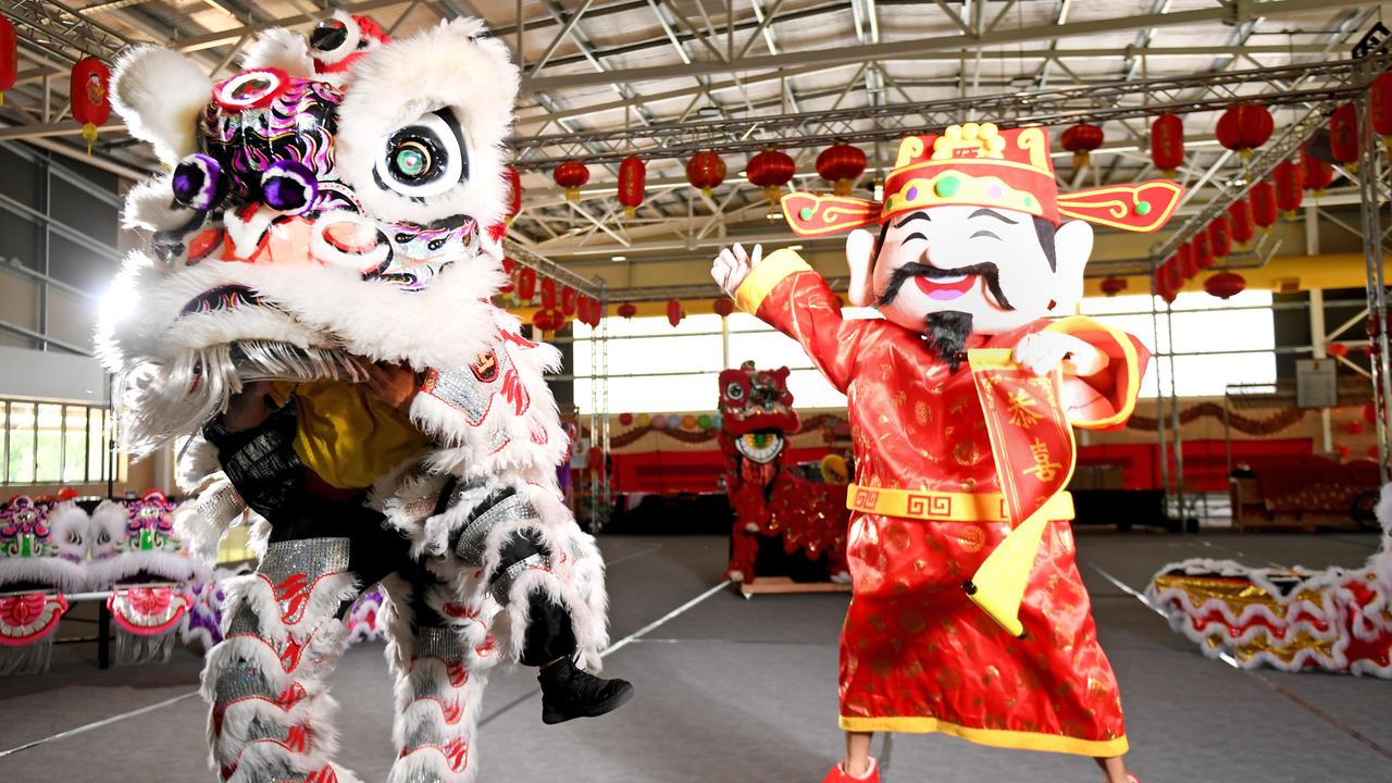 A Lion dancer performs alongside the God of Fortune for Chinese New Year hosted by the Chung Wah Society of Darwin at the Marrara Netball Stadium. Picture: Che Chorley