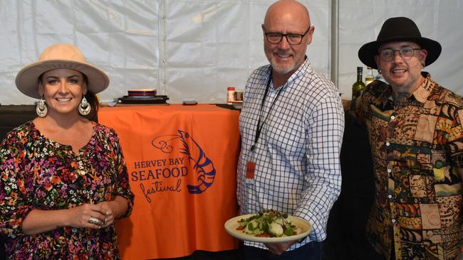 Steph Mulheron, Fraser Coast Councillor Darren Everard and Dan Mulheron presenting cuttlefish with pepper at the Seafood Festival in 2021. Photo: Stuart Fast