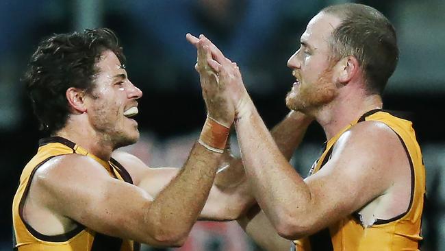 Isaac Smith congratulates Jarryd Roughead after the forward booted another major. Pic: Getty Images