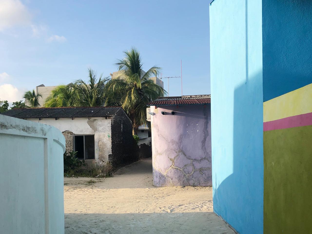The colourful cement houses of the Maldives local villages. Picture: Secret Paradise are painted blue, aqua, pink, yellow and red,