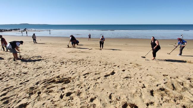 THE FINAL: Participants scour the beach in the final of the Port Curtis Metal Detecting Social Club's pirate treasure hunt at Tannum Sands Beach. Picture: Rodney Stevens