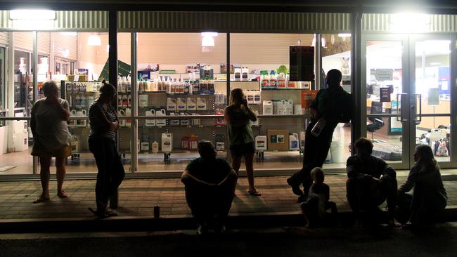 Kangaroo Island residents gather at a local stock store early this morning. Picture: Getty Images