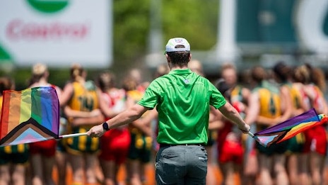 A goal umpire waving their Pride Round flags during the Round 6 match between Waratah and PINT. Picture: Pema Tamang Pakhrin