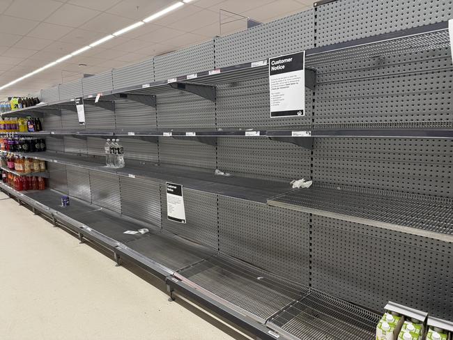 A Woolworths supermarket in Coolangatta with shelves stripped bare of essentials like fresh fruit and vegetables, bottled water and toilet paper. Picture: NewsWire / Glenn Campbell 