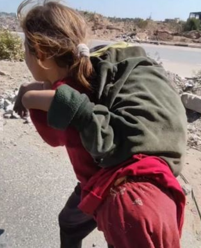 The older girl carries her sister to the car. Picture: Instagram