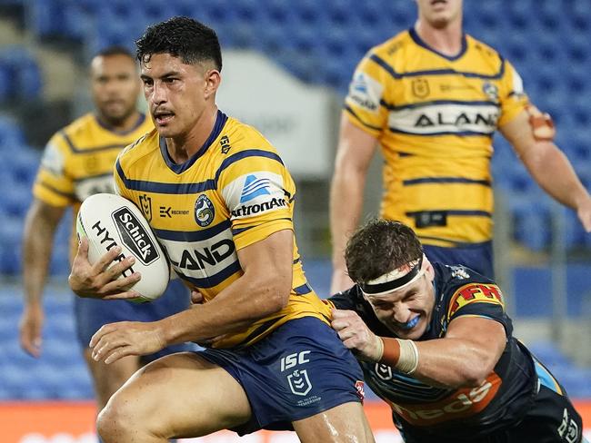 Dylan Brown of the Eels gets through a tackle by Jarrod Wallace of the Titans during the Round 2 NRL match between the Gold Coast Titans and the Parramatta Eels at CBus Super Stadium on the Gold Coast, Sunday, March 22, 2020. (AAP Image/Dave Hunt)