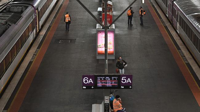 A lone passenger walks along a platform at Southern Cross Station on Friday. Picture: William West/AFP