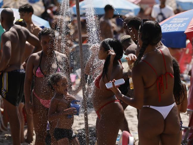 RIO DE JANEIRO, BRAZIL - NOVEMBER 15: Girls take a shower at the beach amid a record-breaking heat wave at Ipanema beach on November 15, 2023 in Rio de Janeiro, Brazil. On the proclamation of the Republic holiday temperature spiked over 42ÃÂ°C (107.6 fahrenheit) as thermal sensation rose to 58.5ÃÂ°C (137.3 fahrenheit).  (Photo by Wagner Meier/Getty Images)