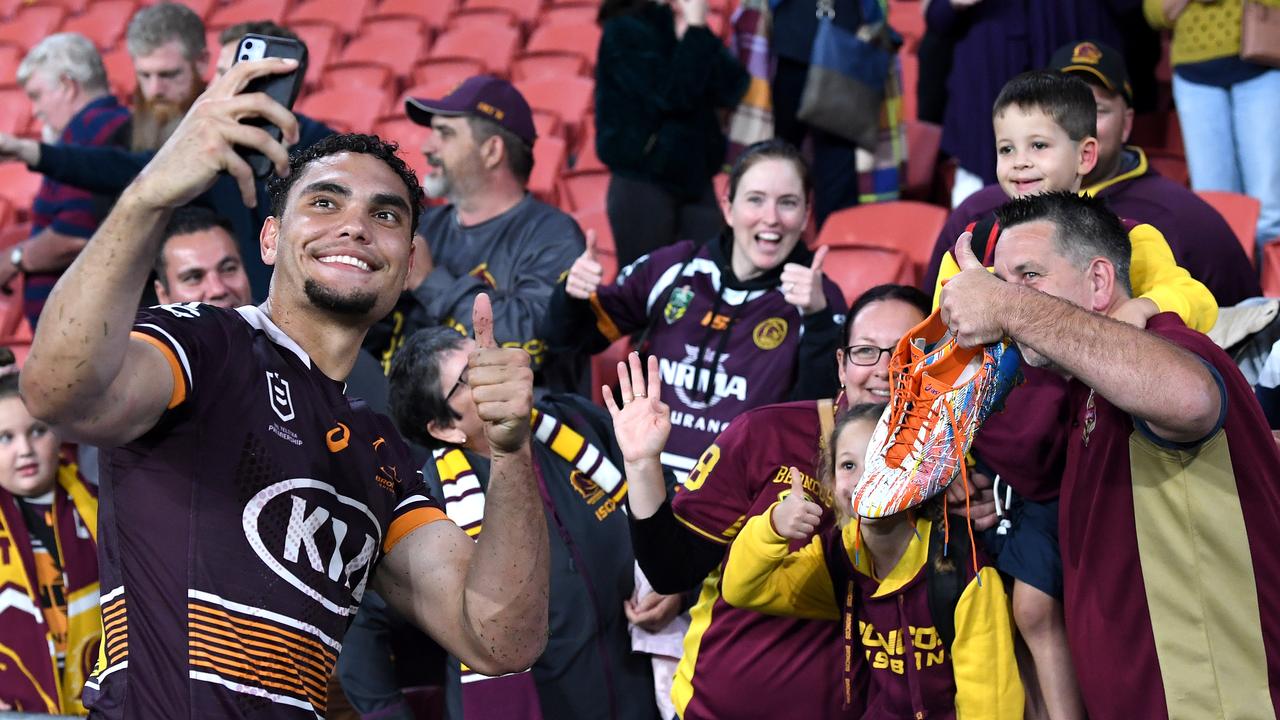 BRISBANE, AUSTRALIA - APRIL 30: Xavier Coates of the Broncos takes a selfie with a young fan that he had just given his playing boots to after the round 8 NRL match between the Brisbane Broncos and the Gold Coast Titans at Suncorp Stadium, on April 30, 2021, in Brisbane, Australia. (Photo by Bradley Kanaris/Getty Images)