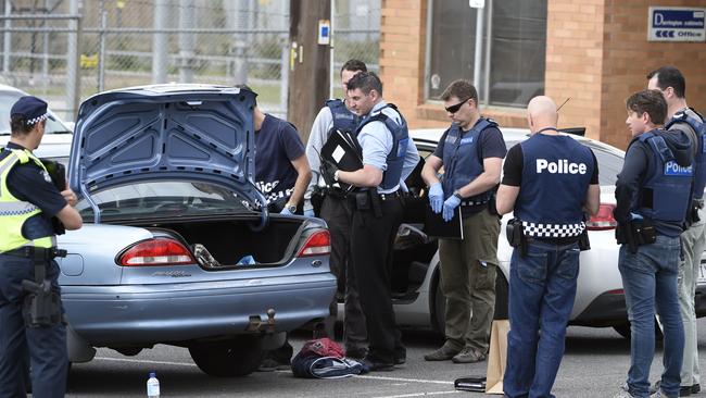 Detectives remove an item from a vehicle parked at the Heatherdale railway station during a raid on the Finks clubhouse in Ringwood in Melbourne, Tuesday, Dec. 15, 2015. The Finks bikie gang is being targeted in a series of police raids across Melbourne. (AAP Image/Mal Fairclough) NO ARCHIVING