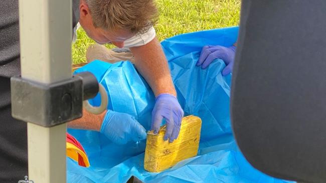 Police inspect a block of cocaine found near Mr Borges. Picture: NSW Police