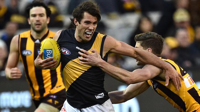 Alex Rance tries to avoid a Luke Breust tackle.