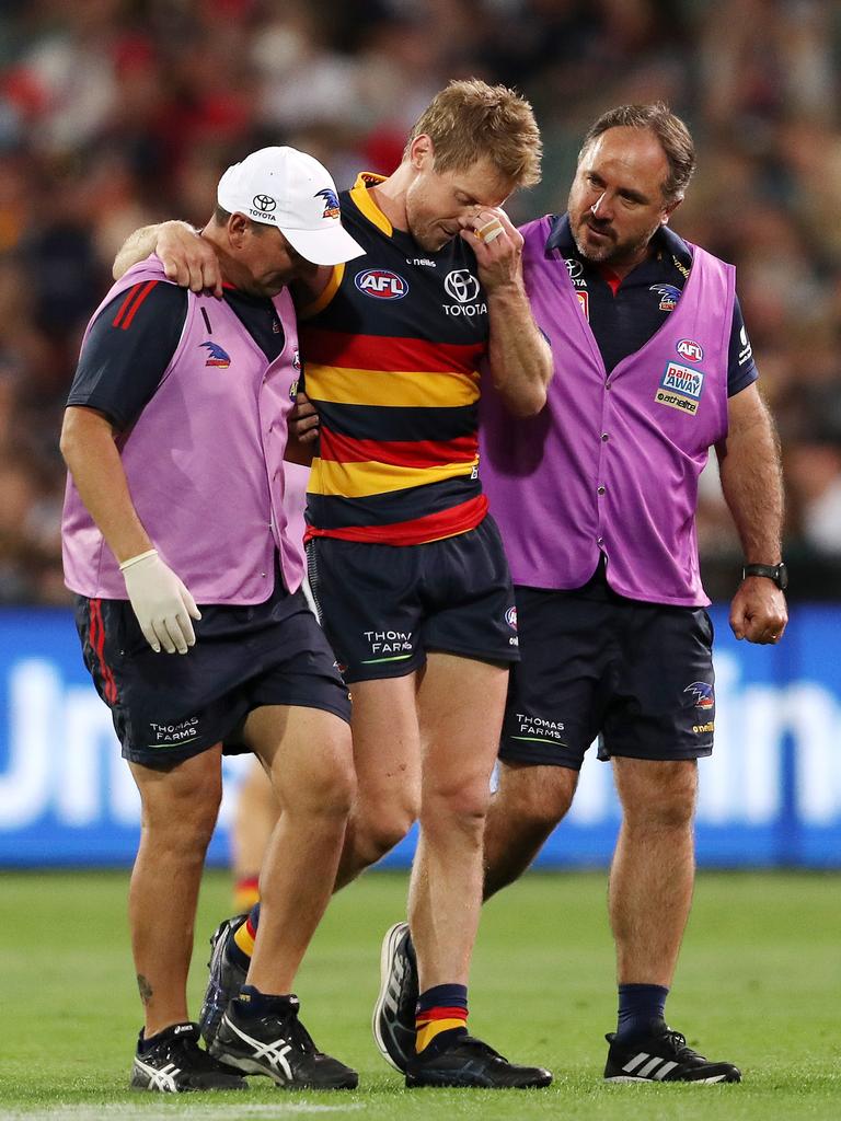 And walking from the ground after tearing his ACL in 2022. Picture: Sarah Reed/AFL Photos