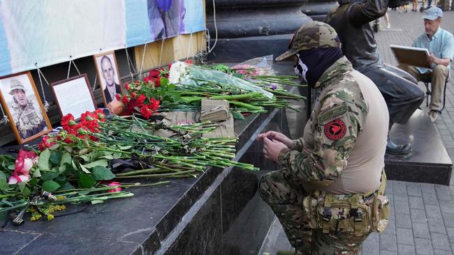 A member of private mercenary group Wagner pays tribute to Yevgeny Prigozhin and Dmitry Utkin in Rostov-on-Don. Picture: AFP.