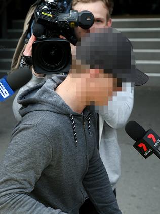 A men who attended the buck’s party dodges reporters in Melbourne. Picture: Ian Currie