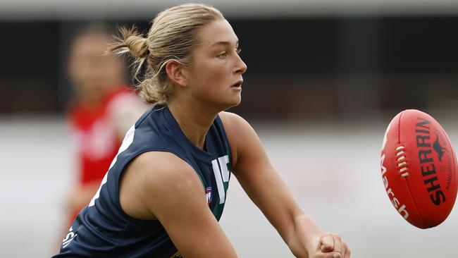 MELBOURNE, AUSTRALIA - APRIL 06:  Ash Centra of the AFL National Academy Girls handballs during the Marsh AFL National Academy Girls vs U23 All-Stars at Ikon Park on April 06, 2024 in Melbourne, Australia. (Photo by Darrian Traynor/AFL Photos/via Getty Images)