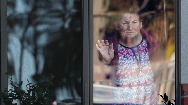 A resident waves from a window at Arcare in Maidstone. Picture: David Crosling