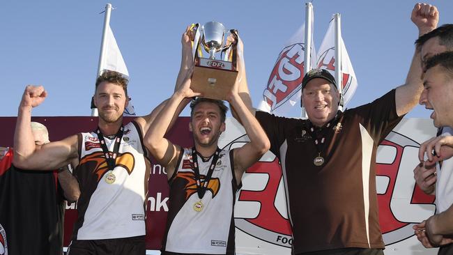 Craigieburn co-captains Christian Mcerlain and Jamie Gorgievski lift the EDFL Division 1 premiership cup with coach Lance Whitnall. Picture: Andy Brownbill