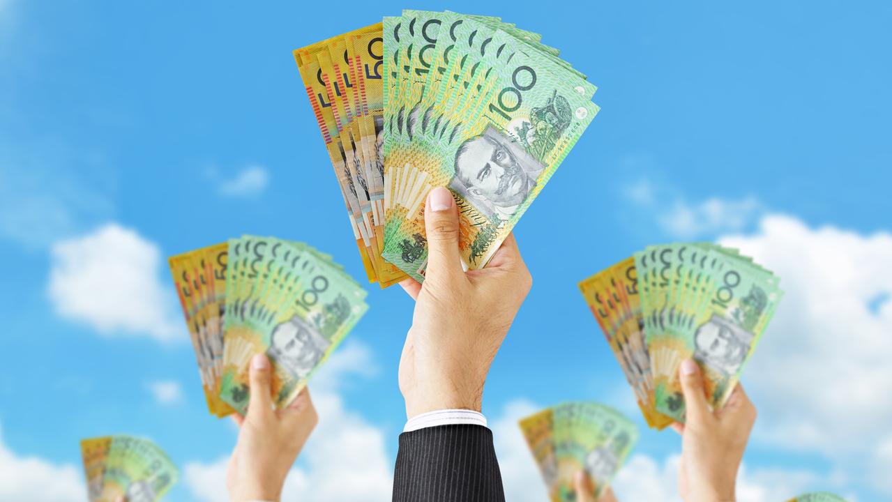 Hands holding money - Australian dollar (AUD) banknotes