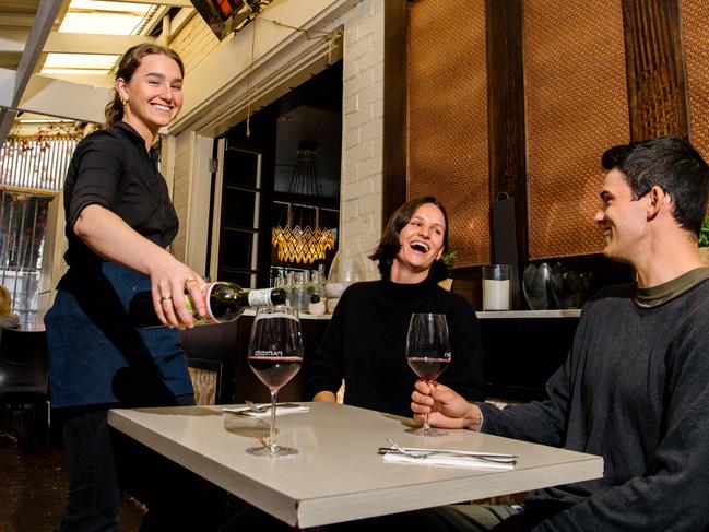 Hannah Morgan serving wine to patrons Harriet Hewitson and Henry Shaw at ParisiÃs in Hyde Park in Adelaide, Friday, May 22, 2020. (The Advertiser/ Morgan Sette)