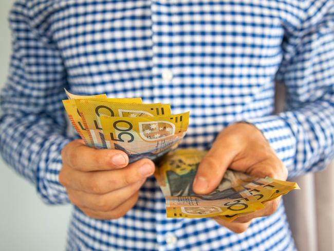 Man handling fifty dollar notes finance. Money and bills economy  Picture: istock