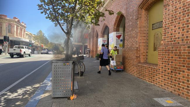 A rubbish bin catches fire outside the WA Supreme Court on Tuesday. Picture: NCA NewsWire / Sharon Smith