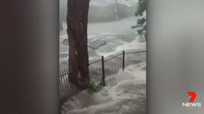 Dramatic footage shows raging floodwaters engulfing a road in Brisbane (7 News)