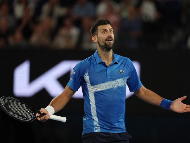 Serbia's Novak Djokovic gestures to the crowd after winning the third set during his men's singles quarterfinal match against Spain's Carlos Alcaraz on day ten of the Australian Open tennis tournament in Melbourne on January 21, 2025. (Photo by Adrian DENNIS / AFP) / -- IMAGE RESTRICTED TO EDITORIAL USE - STRICTLY NO COMMERCIAL USE --