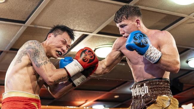 Stoneleigh Jackson lands a shot on Yangcheng Jin during their WBC Australasia Welterweight title fight. Picture: Darren Burns