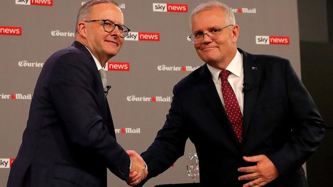 Australian Prime Minister Scott Morrison (R) shakes ahnds with leader of the opposition, Anthony Albanese, during the first leaders' debate of the 2022 federal election campaign at the Gabba in Brisbane on April 20, 2022. (Photo by Toby Zerna / various sources / AFP)