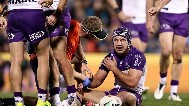 Hughes receives treatment from a trainer during the game. (Photo by Brendon Thorne/Getty Images)