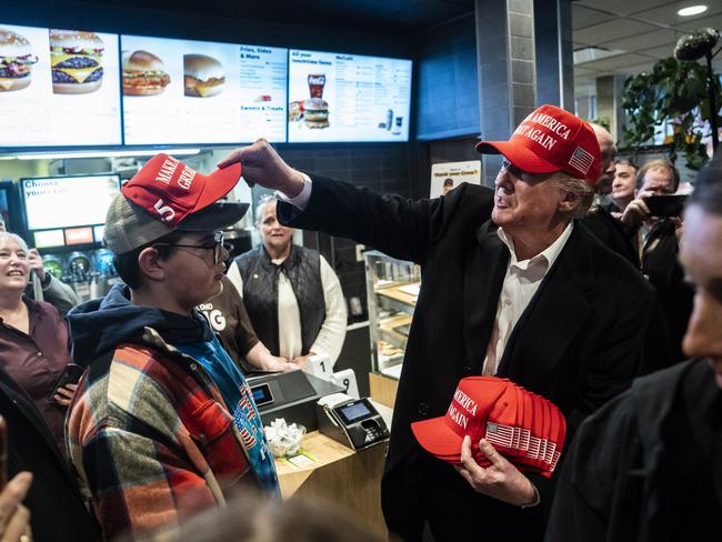 East Palestine, Ohio  - February 22 :  Former President Donald Trump, hands out MAGA hats and greets patrons during an off the record stop at a McDonald's restaurant during a visit to East Palestine, Ohio, following the Feb. 3 Norfolk Southern freight train derailment on Wednesday, Feb. 22, 2023, in East Palestine, Ohio. (Photo by Jabin Botsford/The Washington Post via Getty Images)