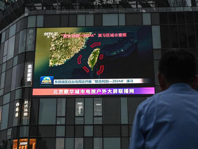 An outdoor screen in Beijing shows news coverage of China’s military drills around Taiwan. Picture: AFP