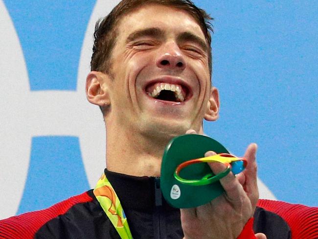 RIO DE JANEIRO, BRAZIL - AUGUST 09: Gold medalist Michael Phelps of the United States poses on the podium during the medal ceremony for the Men's 200m Butterfly Final on Day 4 of the Rio 2016 Olympic Games at the Olympic Aquatics Stadium on August 9, 2016 in Rio de Janeiro, Brazil. (Photo by Adam Pretty/Getty Images)