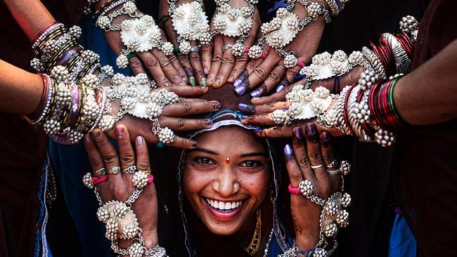 EMBARGO 9PM WEDNESDAY NOVEMBER 18TH © Sanghamitra Sarkar, India, Entry, Open, Smile, 2016 Sony World Photography Awards Tribal women of Gujrat in India wearing traditional silver ornaments and blessing a newly married girl.