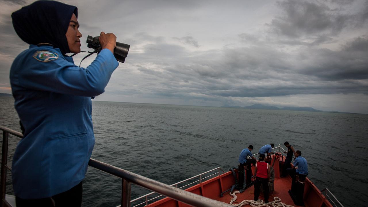 (A member of Indonesia's National Search and Rescue looks over horizon during a search in the Andaman Sea around the northern tip of Indonesia's Sumatra island for the missing Malaysian Airlines MH370 plane on March 17, 2014. Picture: Chaideer mahyuddin/AFP