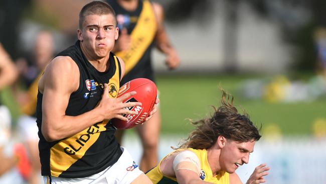 ANZAC DAY SANFL. Glenelg v Eagles at Woodville Oval - Glenelg no 6 Hugh Stagg and Eagles no 49 Zachary Buck on the 25th April, 2022. Picture: Tricia Watkinson