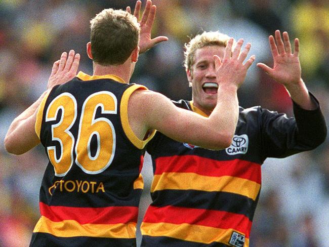 Simon Goodwin celebrates with Kane Johnson in a 2001 match. Their tight friendship has long outlasted their playing days, with Goodwin calling upon Johnson for advice through difficult times in his coaching career. Picture: Sarah Reed/NCA