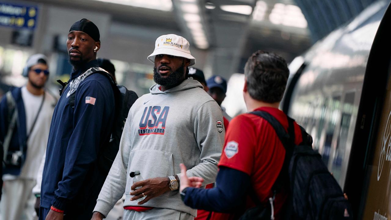 Bam Adebayo (left) and LeBron James prepare to board the train. (Photo by Benjamin Cermel/AFP)