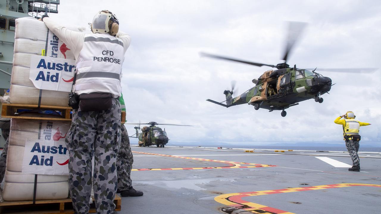 An Australian Army MRH-90 Taipan launches from the flight deck of HMAS Adelaide to drop disaster relief supplies to Nabouwalu on the island of Vanua Levu, Fiji, during Operation Fiji Assist. Picture: CPL Dustin Anderson/Defence