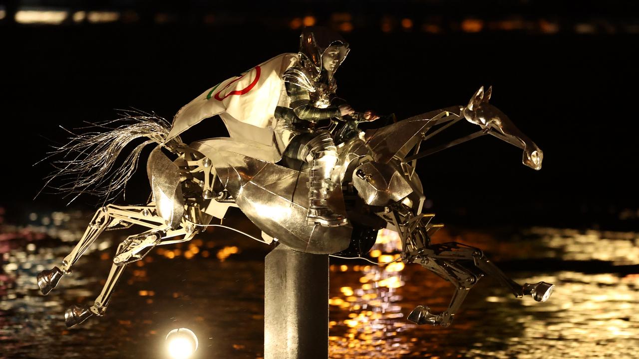 PThe Horsewoman, wearing the Flag of the International Olympic Committee (IOC) galloping down the Seine. PIcture: Richard Pelham/Getty Images