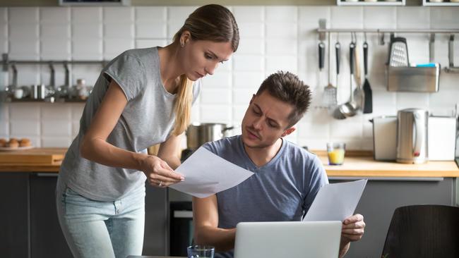 A couple assessing their household costs including their home loan rate. Picture: iStock