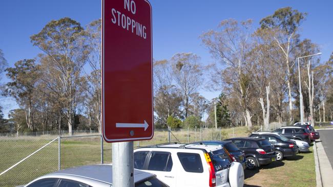 Cars parked on the grass verge at Edmondson Park train station. Picture: Melvyn Knipe