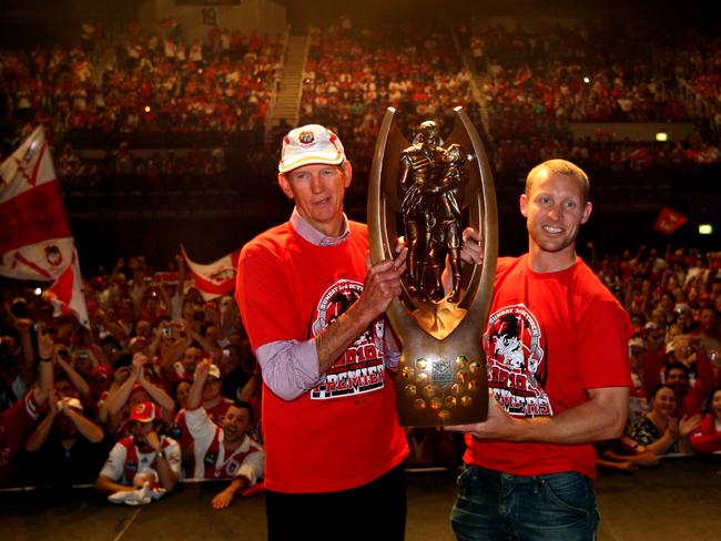 Coach Wayne Bennett (L) and captain Ben Hornby show off the Telstra Premiership trophy to the fans packing the WIN Entertainment Centre in Wollongong to celebrate victory with players day after St George-Illawarra Dragons defeated Sydney Roosters in 2010 NRL Grand Final.